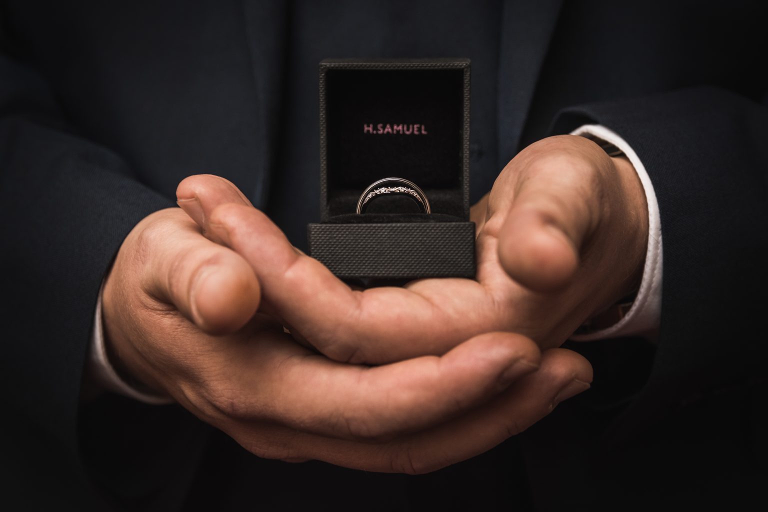 a groom holds wedding rings at beverley registry office