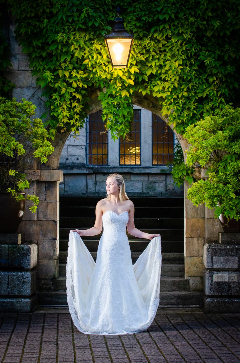 a bride shows her dress at hazelwood castle east yorkshire