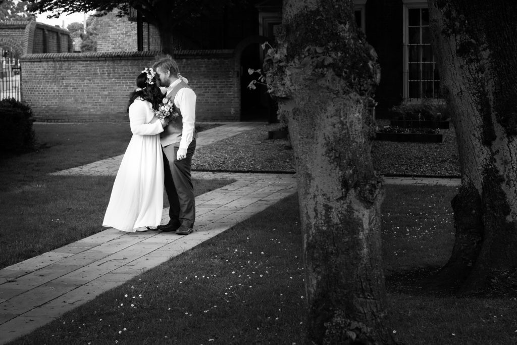 a bride and groom embracing in the grounds of Beverley registry office.