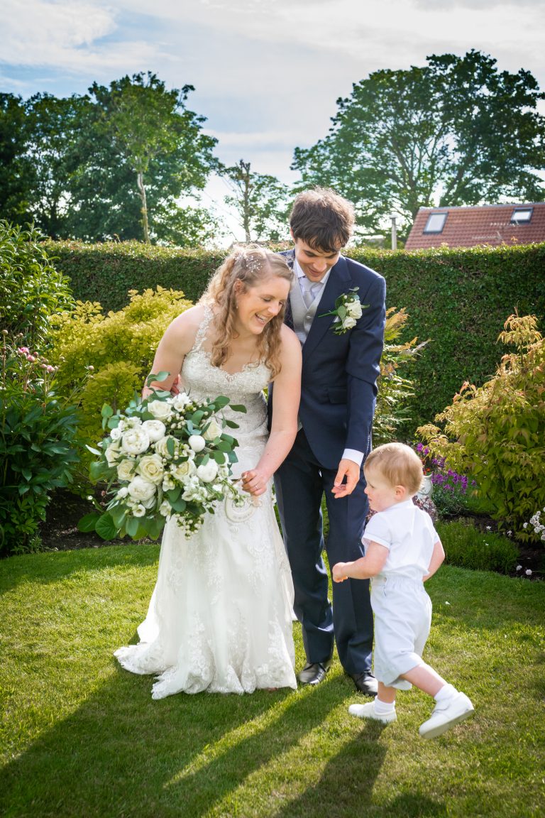 a relaxed image of a newlywed couple and a younger relative in east yorkshire