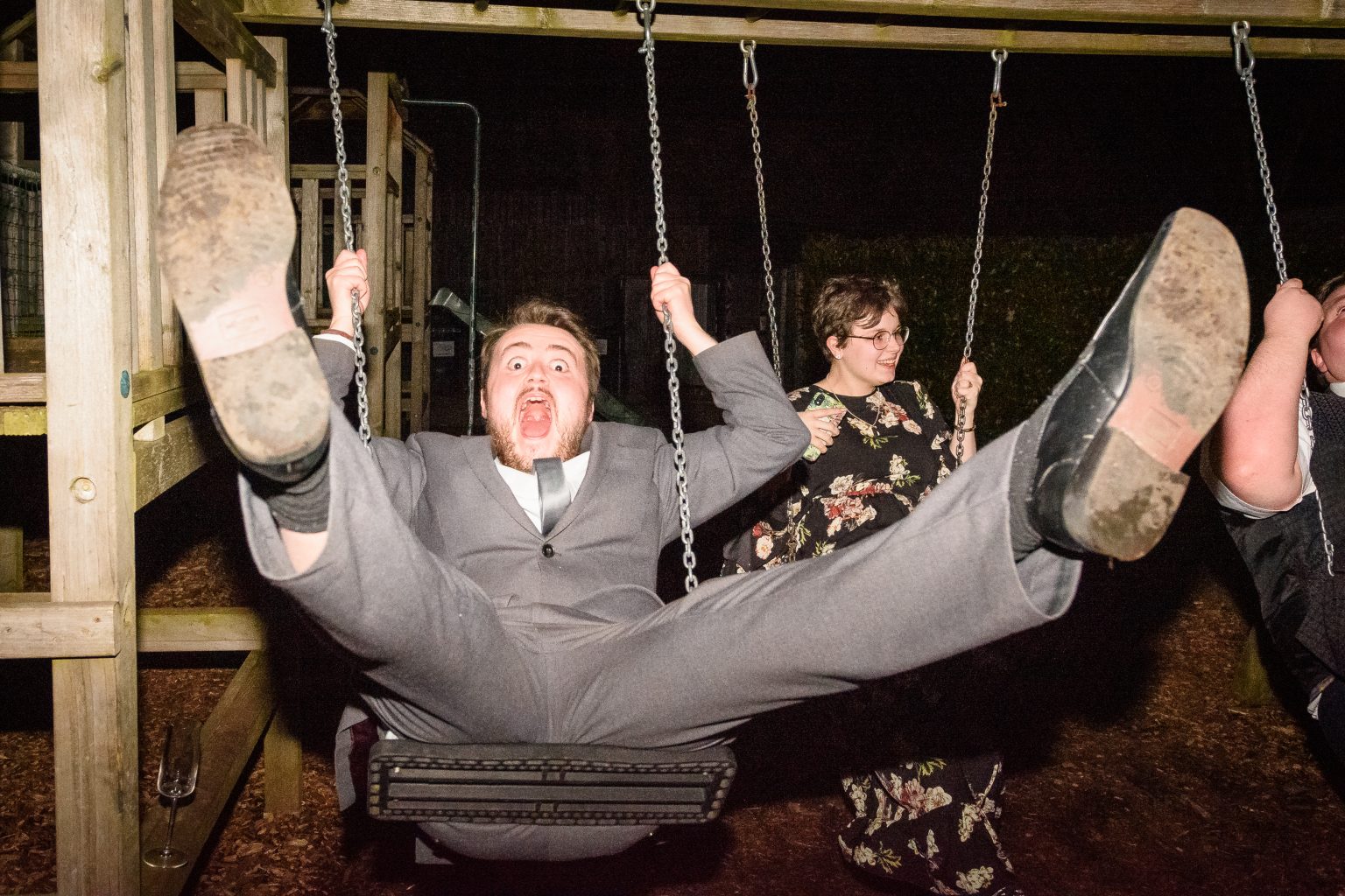 wedding guests using the swings at a recption at the triton inn brantingham