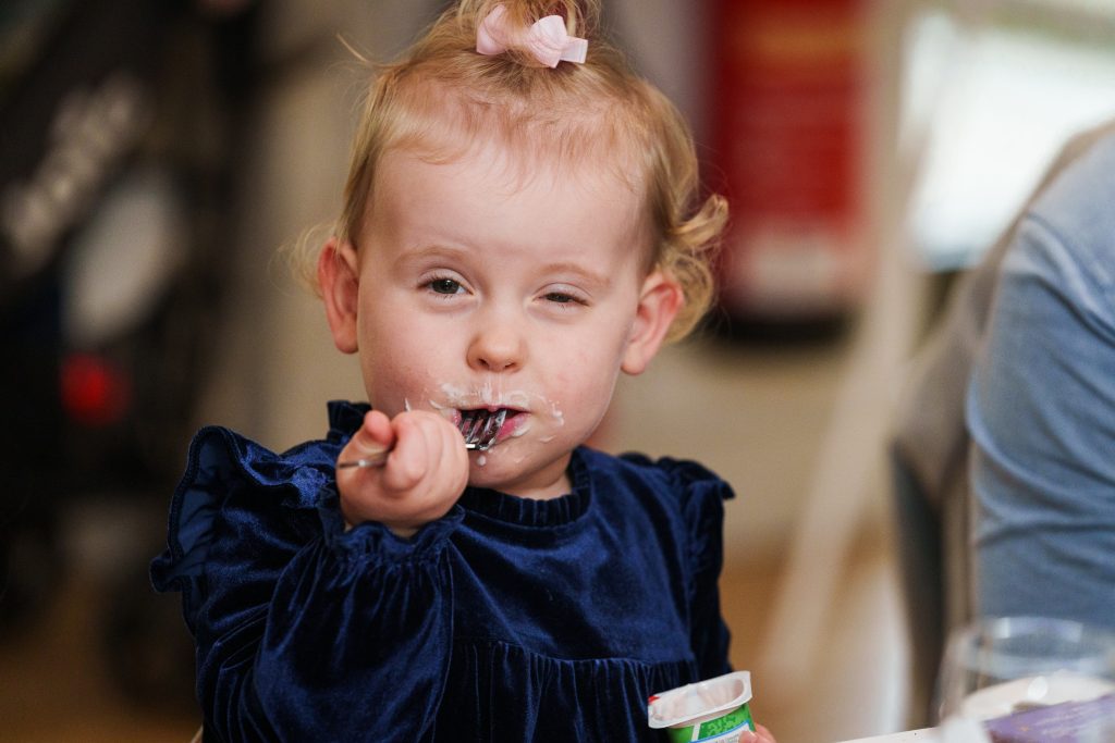a child eating yogurt at lazaat hotel wedding reception scaled