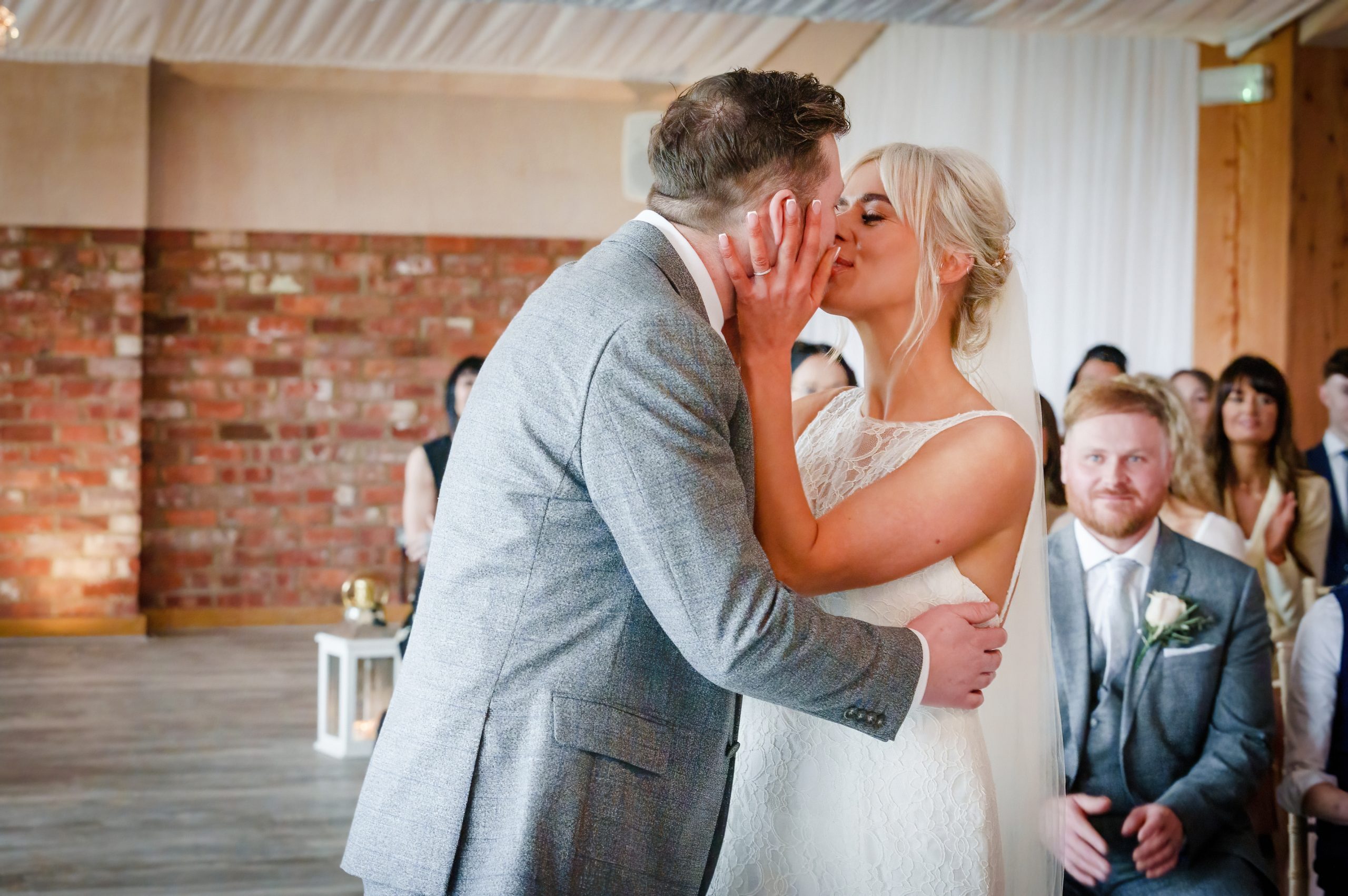 a couple kissing during their wedding ceremony at the barn at willerby hill near cottingham scaled