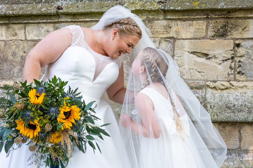 bride and her daughter playing under the brides veil east yorkshire