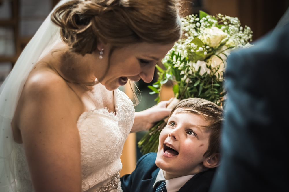 bride smiling at young relative at a church wedding