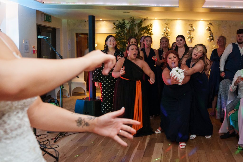 bride tosses the bouquet at lazaat hotel cottingham scaled