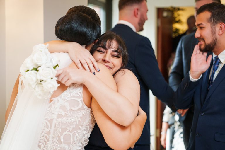 lazaat hotel bride hugs her bridesmaid after the wedding ceremony scaled