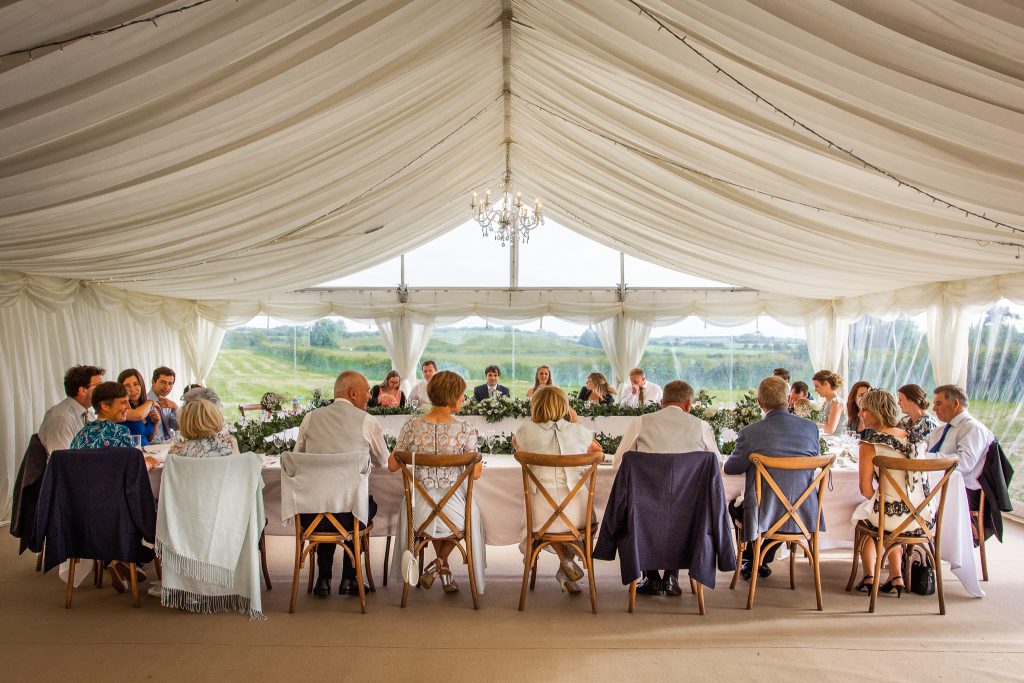 Wedding guests in a hired marquee on a family member's farm.